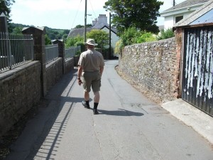 Cars and pedestrian share the road, Laugharne, Wales